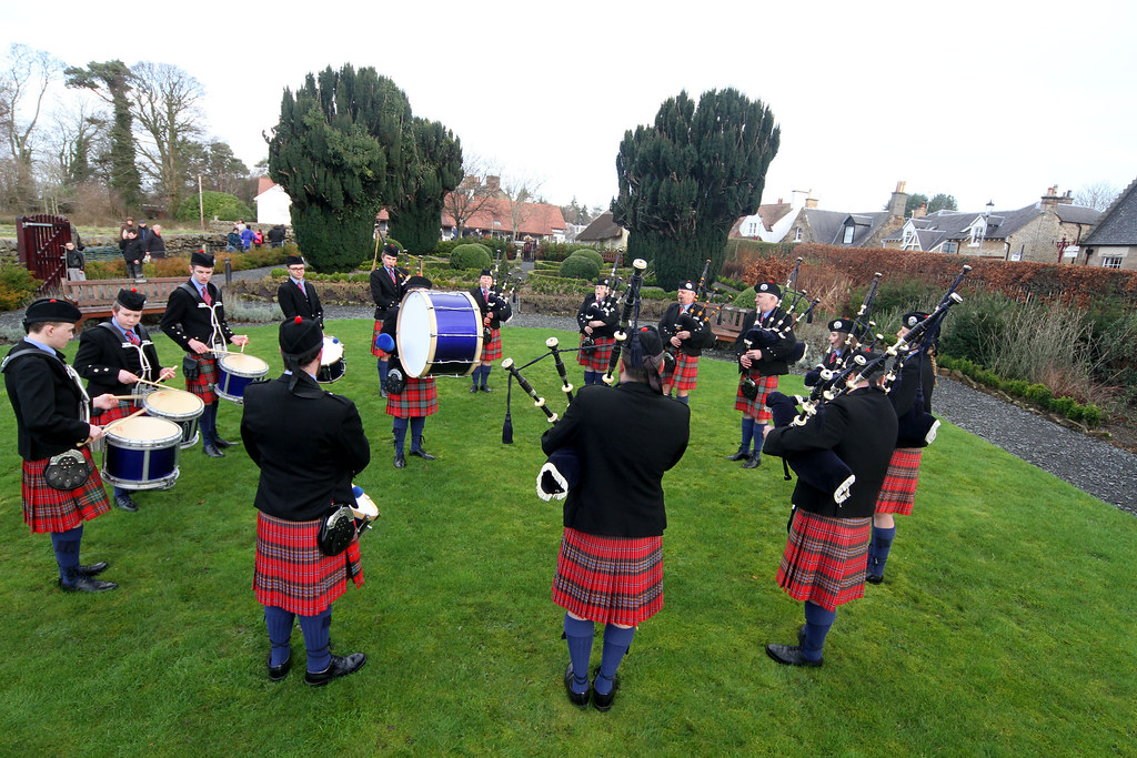 A pipe band playing on a village green
